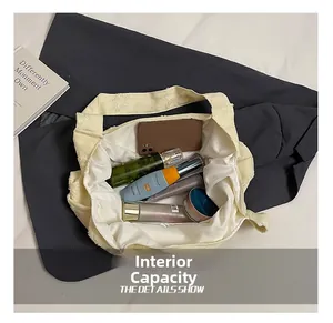 Top view of the spacious inner compartment of the beige tote bag showing daily essentials