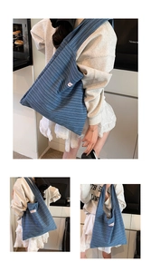 Detail of blue striped corduroy tote bag showing textured fabric and side woven label