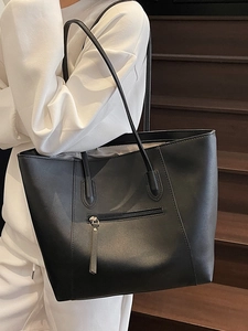 Minimalist black matte leather tote bag with front zipper pocket and long shoulder straps