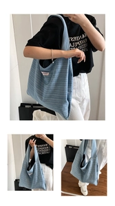 Detail of light blue knitted tote bag showing thick striped texture and small pink tag