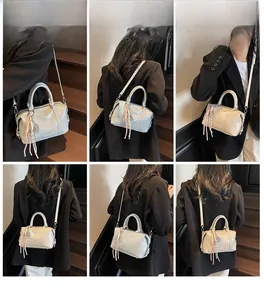 Detail shots of beige soft leather bowling bag featuring letter embossing and tassels