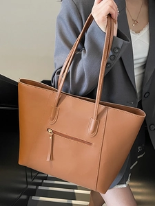 Minimalist large capacity brown leather tote bag with slim shoulder strap and zipper pocket