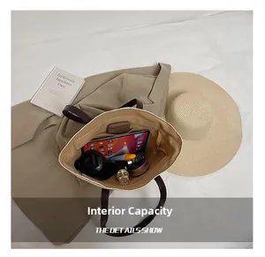 Top view of spacious straw tote bag interior with pockets, tablets, and water bottle