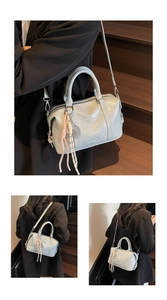 Detailed view of grey-blue leather bowling bag with 3D embossed letters and woven charm