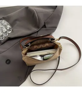 Macro view of nylon crossbody bag interior holding a smartphone and branded wallet