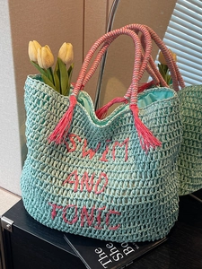 Mint green straw woven tote bag with pink Swim and Tonic embroidery and tassel