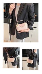 Detail view of mini nylon crossbody bag in pink with top handle and gold hardware