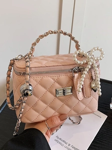 Pink quilted leather box bag with silver lock, pearl bow charm and chain strap