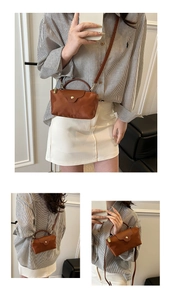 Detail view of brown nylon mini bag with leather flap and detachable shoulder strap