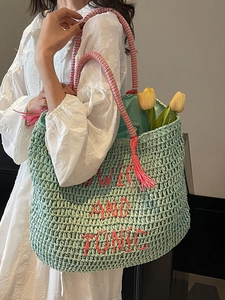 Mint green woven tote bag with GIN AND TONIC embroidery and pink tassel straps