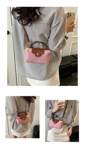 Detailed views of a mini pink nylon dumpling bag with leather trim and gold hardware