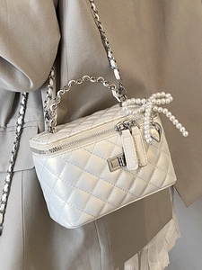 Elegant white quilted crossbody bag with pearl bow and gold chain strap for women