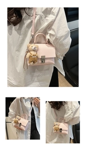 Detail of light pink leather crossbody bag with silver twist lock and cute bear charm