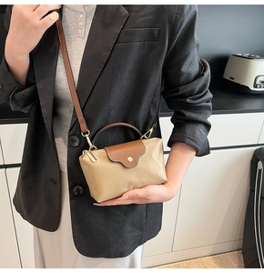 Mini beige tote bag with brown leather details shown on model in modern office setting