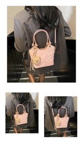 Detail of pink wave-textured bucket bag with a plush bear charm and knotted handle