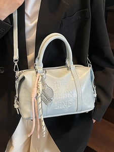 Retro mint green leather Boston bag with embossed lettering and tennis racket charm