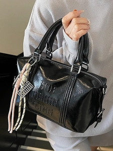 Glossy black bowling bag with Hob Fishin Ling embossing and colorful woven strap