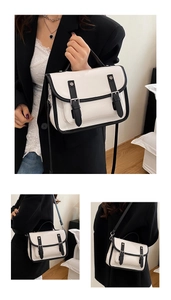 Detailed views of white lychee leather satchel with black contrast edges and top handle