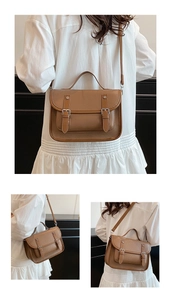 Detailed view of brown retro messenger bag with lychee texture and buckle design
