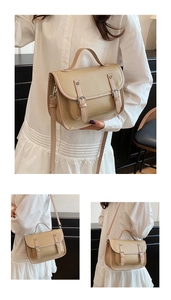 Detail of khaki pebbled leather messenger bag with retro buckle and adjustable strap