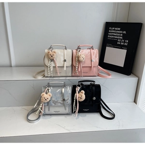 Four elegant mini backpacks in white, pink, silver, and black with cute bear charms