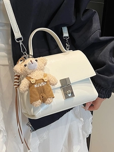 Minimalist white leather handbag for women featuring a metal buckle and cute bear charm