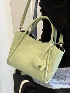 Minimalist light green litchi pattern bucket bag with elephant charm and strap