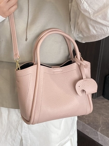 Pink lychee texture leather bucket bag with elephant charm and detachable strap