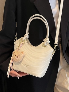 Minimalist white bucket bag with wave texture and cute bear charm for women