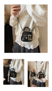 Détail du mini sac matelassé noir avec zips dorés et bandoulière chaîne avec perles