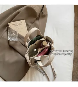 Spacious interior of beige lychee leather bucket bag with multiple compartments and zipper