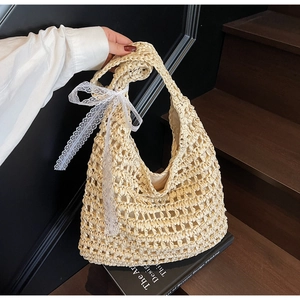 Detail of hollow straw tote bag with elegant white lace ribbon and fabric lining