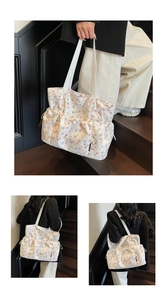 Detail view of floral tote bag with three drawstring pockets and wide woven shoulder strap