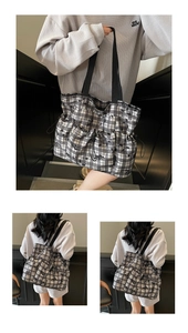 Detail of black and white checkered tote bag featuring side drawstrings and black strap
