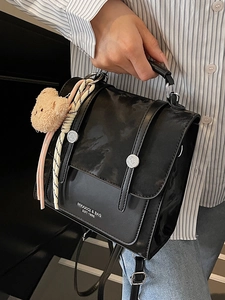 Versatile black PU leather backpack with silver buckles and a cute plush bear charm