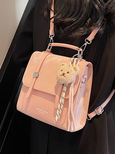 Pink minimalist crossbody bag with metal snap and cute plush bear charm for women