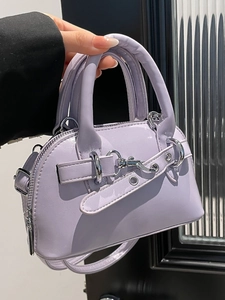 Chic lavender shell handbag with shiny finish and silver hardware shown held by hand