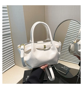 Detail of white pleated oil wax leather bucket bag with gold buckle and top handles