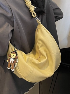 Minimalist pale yellow hobo tote bag with knotted shoulder strap and soft pebble leather