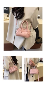 Detail view of pink lychee leather handbag showing front zipper pocket and shoulder strap
