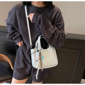 Detail view of light blue lychee pattern bucket bag with a trendy handle and strap