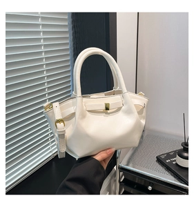 Detail of cream white pleated bucket bag with gold buckle and smooth oil wax leather