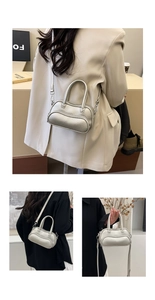 Close-up of silver lychee texture leather on mini bowling bag with detachable strap
