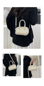Detail of cream lychee texture leather mini bowling bag with silver metal buckles