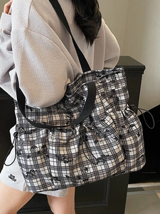 Black and white checkered tote bag with butterfly print and drawstring closure