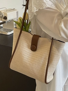 Minimalist woven tote bag with brown leather trim and tulip detail for casual commuting