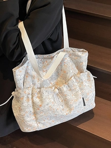 Floral print tote bag with white lace overlay and drawstring side pockets for women