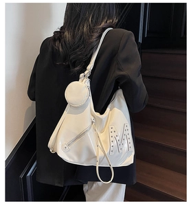 Detail of white PU leather hobo bag with铆钉 M decoration and mini round coin pouch