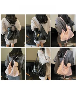 Detail view of large shoulder bag with rivet M design and mini pouch in black and pink