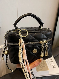 Mini sac boîte matelassé noir avec chaîne, détail fleur de camélia et finitions dorées